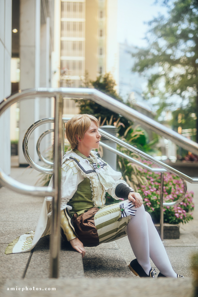 Sitting on some post modern office steps while dressed as the fancy lad. It manages to look a bit like a fancy 80s soft focus music video. 
Watermark reads amiephotos.com