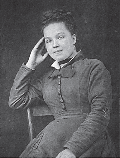 Black and white photo of Augustine Gleizes. It's a portrait of a young girl, looking serenely at the camera, wearing a plain, neat 19th century dress and her hair braided and pinned up. 