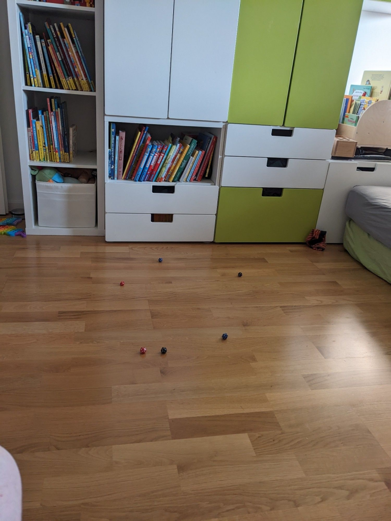 Floor of a kids room with scattered 20 sided dice