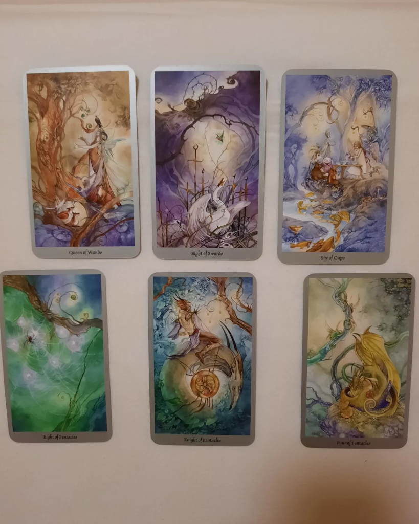 A few Shadowscapes Tarot cards spread out. This one is a lovely, soft watercolor deck with graceful designs.