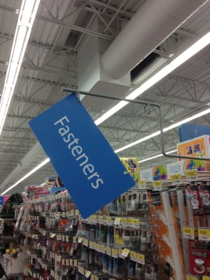 sign in a big box store that is hanging loosely at an angle, which says: fasteners