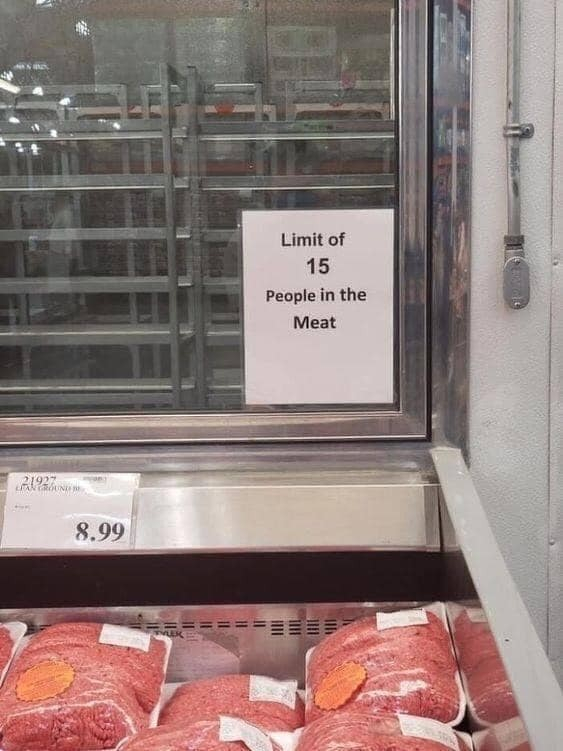 sign at a meat counter with ground meat in it that says: Limit of 15 people in the meat