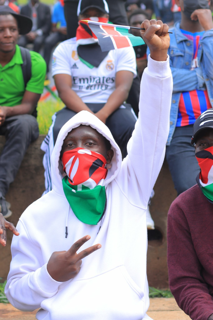 Kenyan protesting with a Kenyan flags 