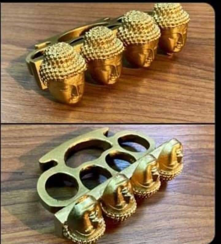 Brass knuckles with the head of buddha on each knuckle