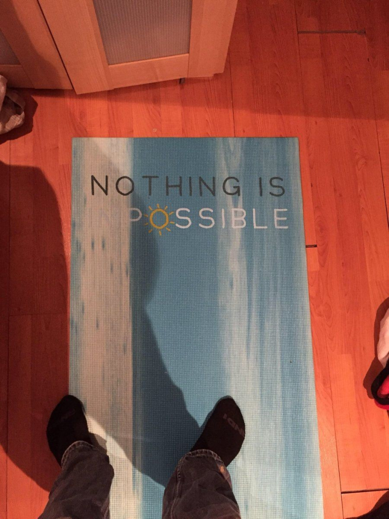 a rug design that is supposed to say Nothing Is Impossible, but because of the low contrast, it says: Nothing is possible.