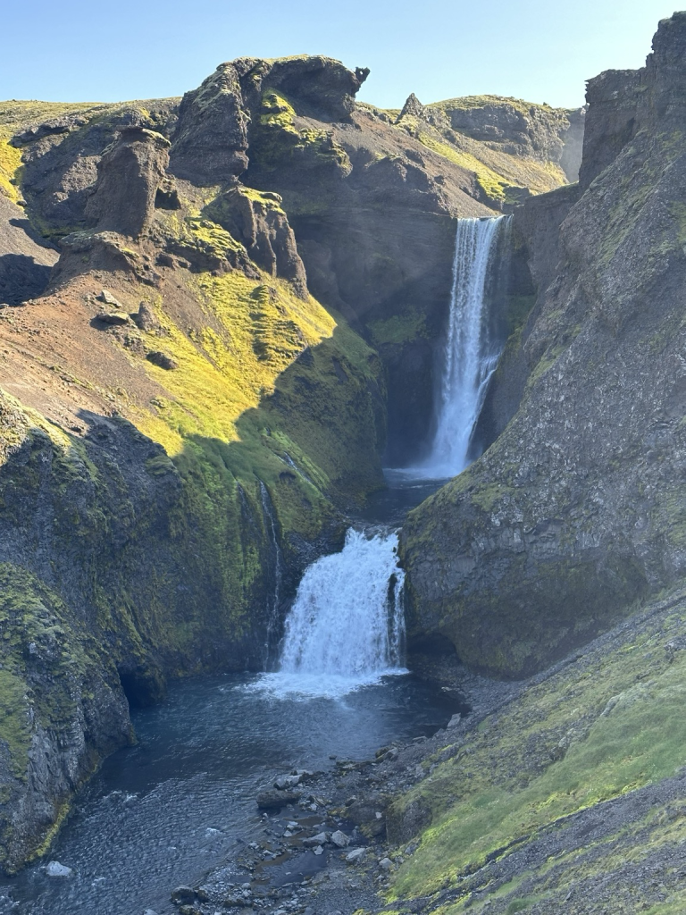 A high double waterfall on a blue sky day. 