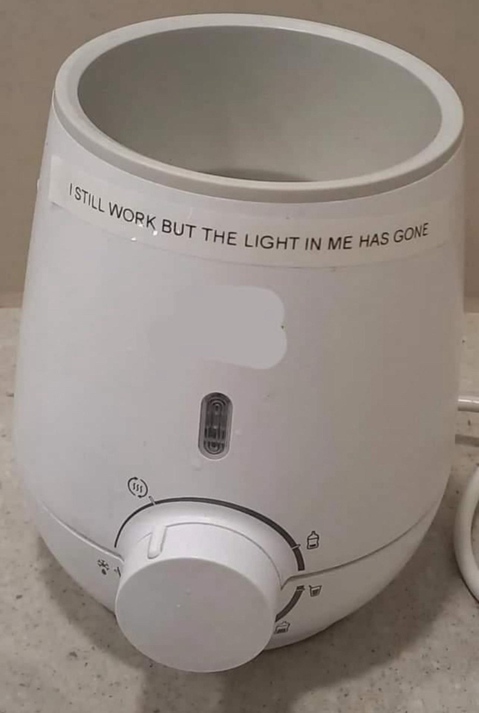 a humidifier that has a hand-made label on it that says: I still work but the light in me has gone