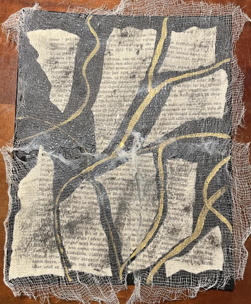 Now you can see the paper with the Icelandic writing and the black background with the gold streaks under the cheesecloth.  There are also grey smudges in places. 