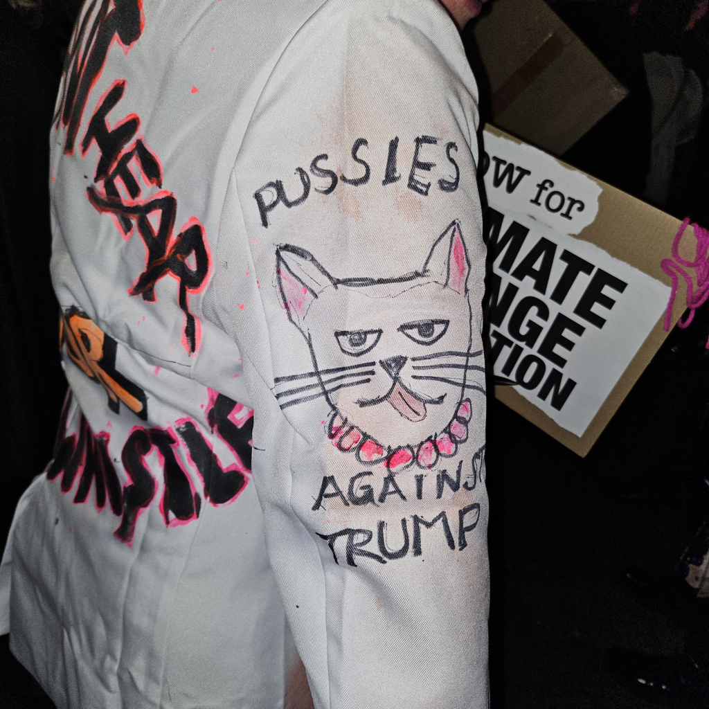 A white sleeve with a cat drawn on it. Around it says Pussies Against Trump