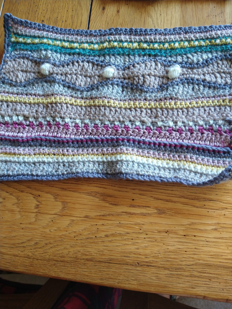 Rectangular crochet piece, which has a wave pattern and bobble stitches and beading 