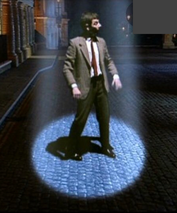 Mr. Bean surpised in a beam of light from heaven.