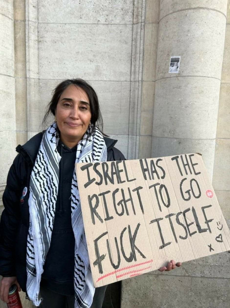 Woman holding a sign saying Israel has the right to go fuck itself