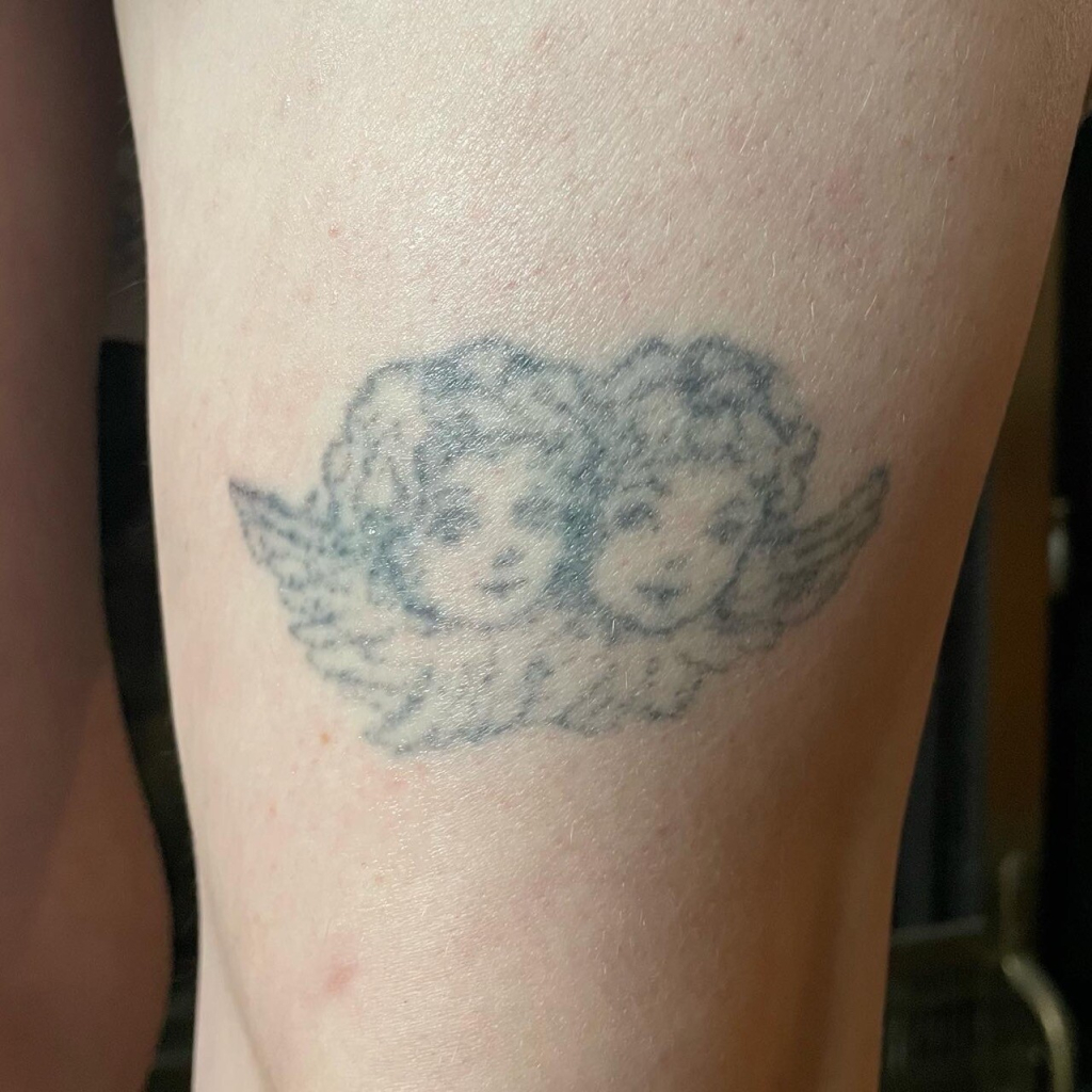 cherub tattoo, an 8 year old stick and poke