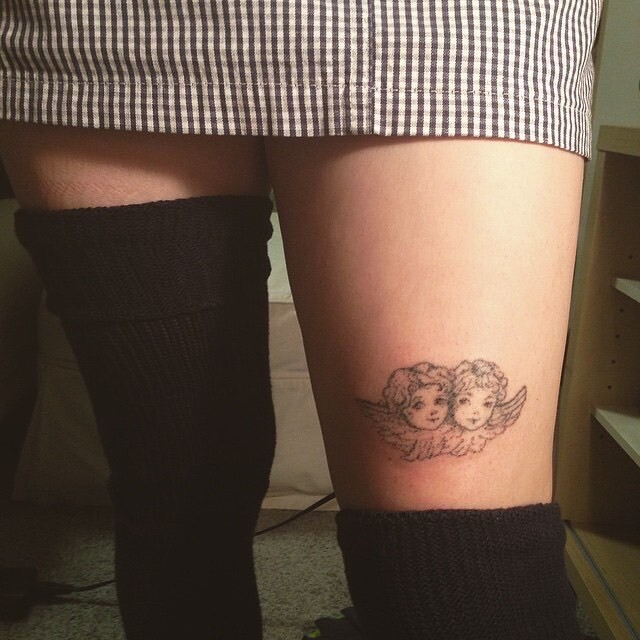 cherub tattoo, freshly poked with India ink and a sewing needle like God intended