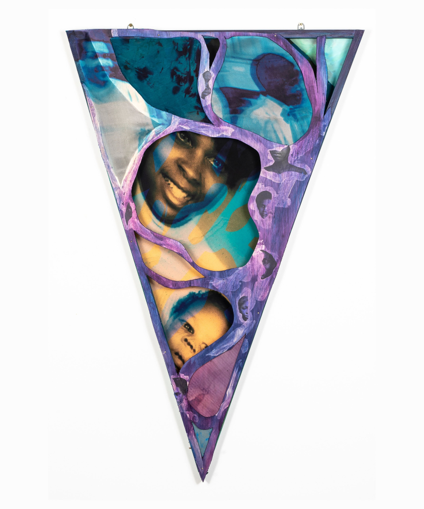 Triangle pennant-shaped textile with printed images of a Black family overlaid with semi-sheer purple material