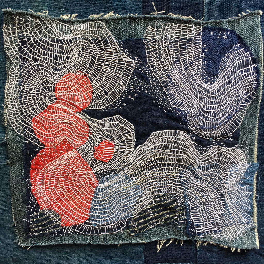 Abstract embroidery with swirling white threads