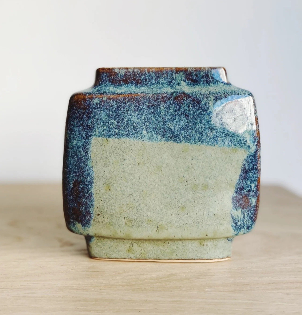 Ceramic vase in a loose square shape with blue and cream glaze