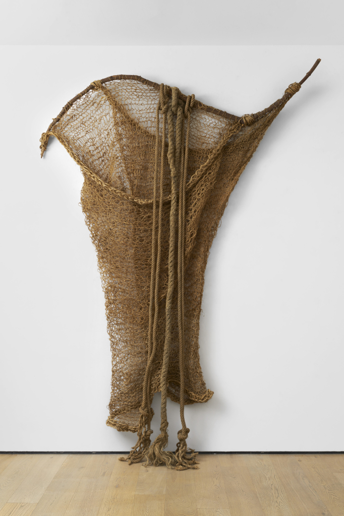 Hanging sculpture made of loosely woven soft brown rope