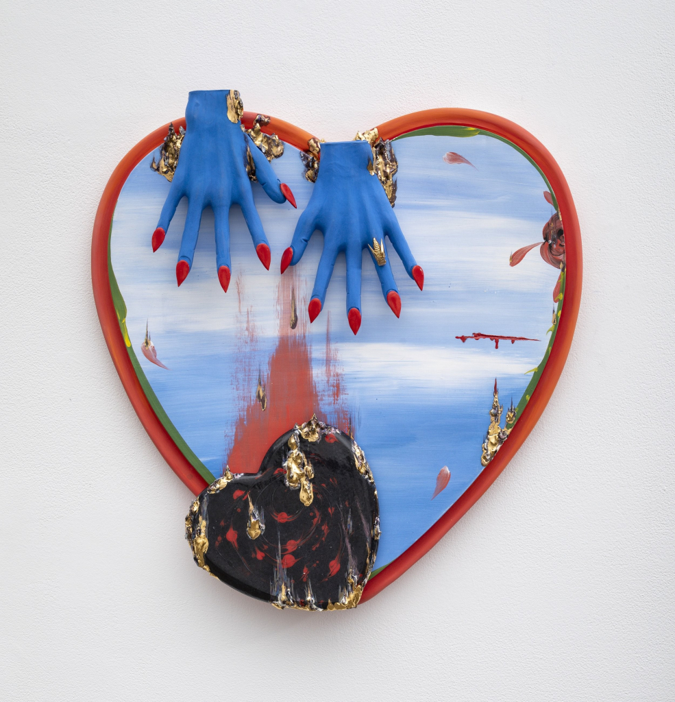 Hanging wall sculpture of a heart painted blue and white overlaid with blue outstretched hands with red pointed nails, and a black and gold heart falling off the base