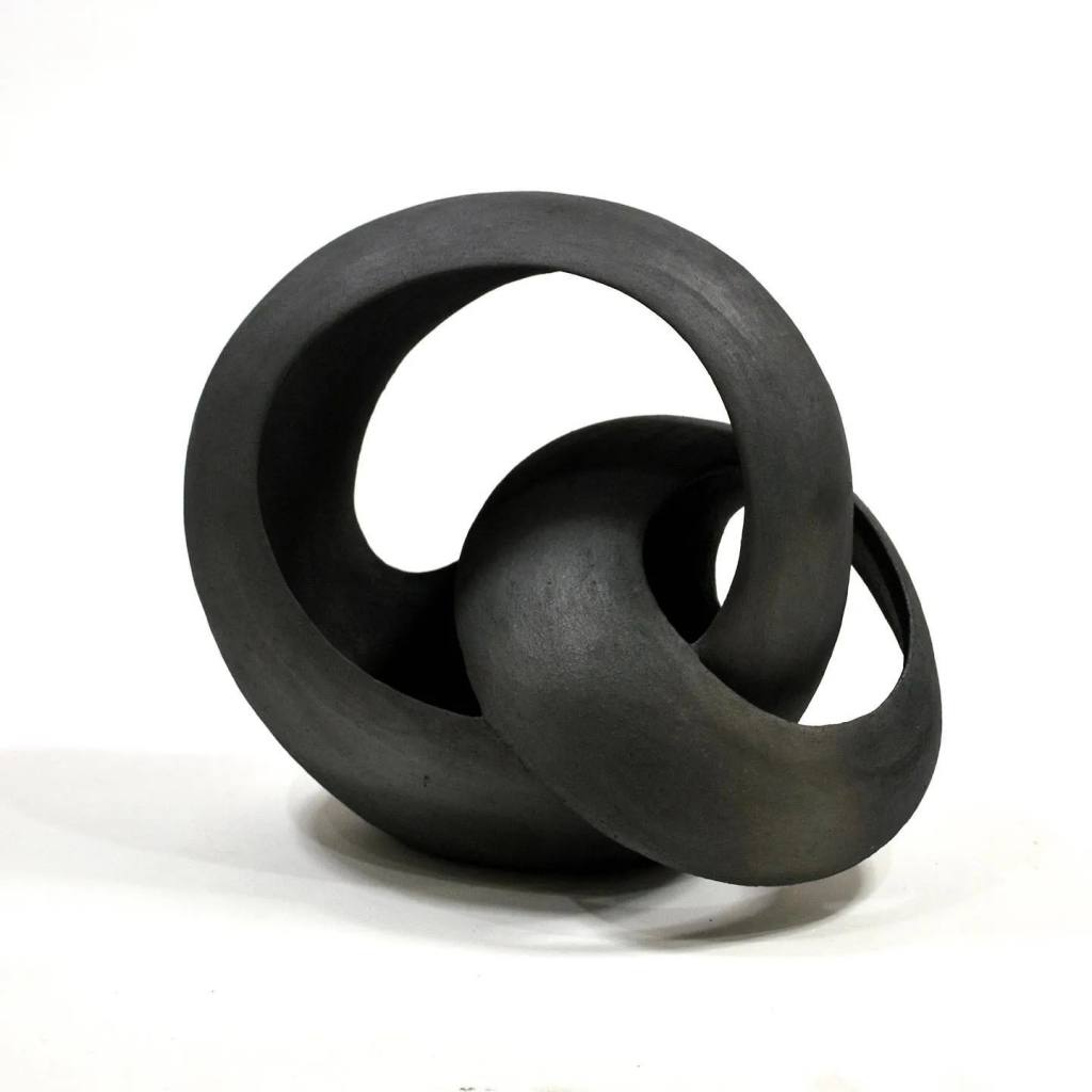 Black abstract sculpture of two linked open circles