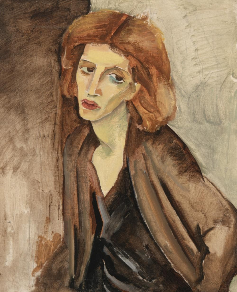 Portrait of a woman with medium brown hair and dark brown clothing leaning against a sparse wall, her face wearing a pained expression