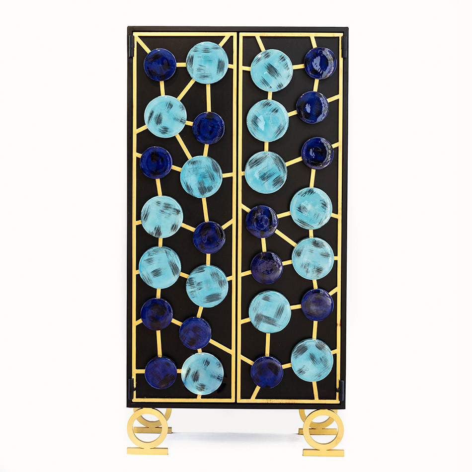 Tall cabinet in black and gold, covered in light and dark blue circles