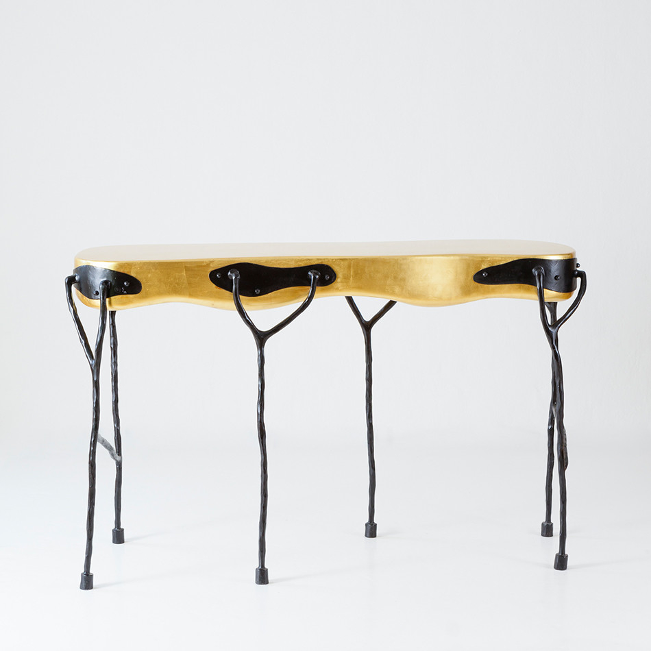 Gold table with spindly black legs