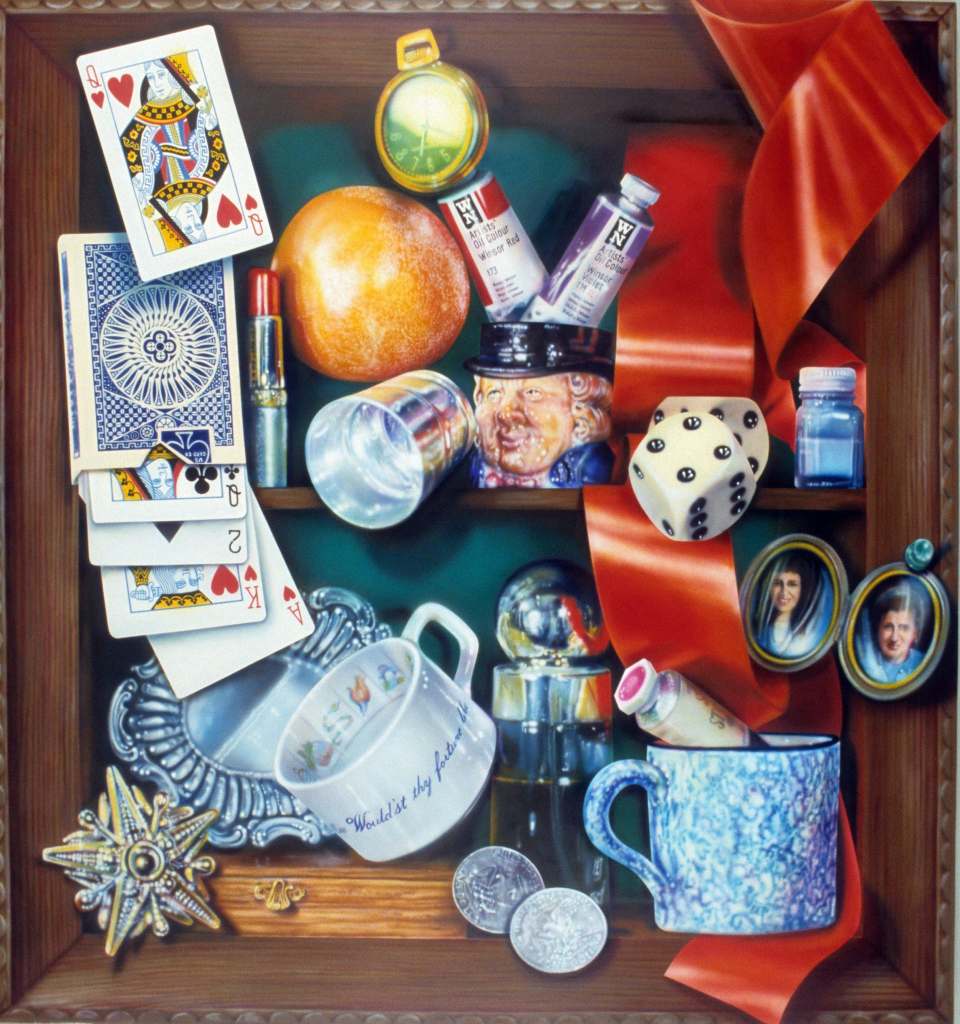 Photorealistic still life painting with a cluster of objects, including a pack of cards, pair of dice, paint tubes, teacup, and red ribbon