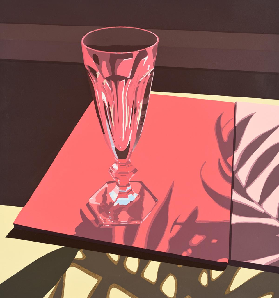 Print of a narrow drinking glass with classic cut pattern sitting on a red surface, with shadows of leaves falling across it