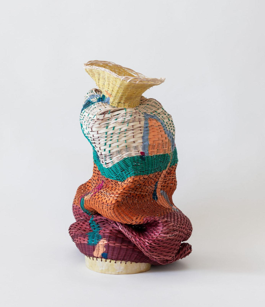 Basket weave sculpture in various colors, with a drooping, folded effect at the bottom