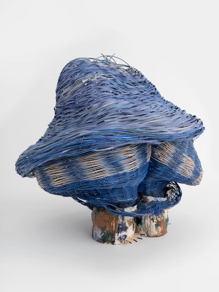 Basket weave sculpture in blue and cream, resembling a little mushroom