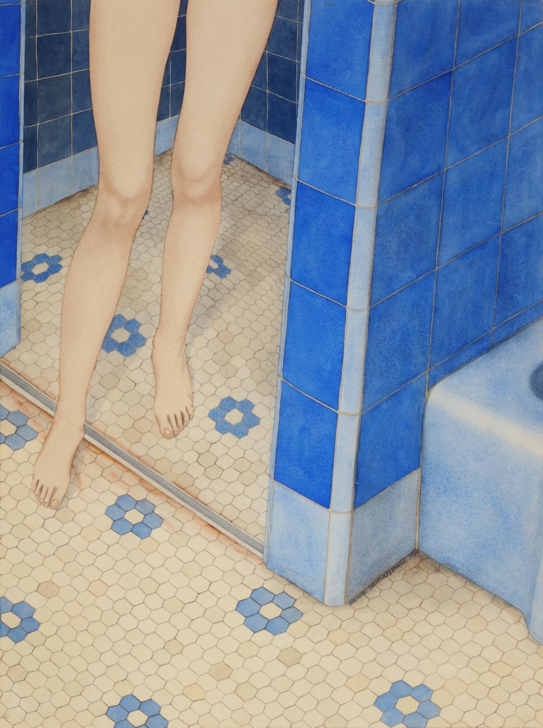 A person's pale bare legs are seen stepping out of a shower stall, covered in blue wall tile and a floral tile pattern on the floor