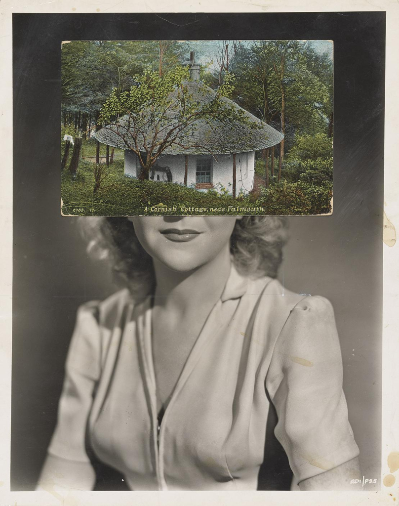 Black and white photo of a smiling blonde woman wearing a light v-neck blouse, her upper face is covered by a color postcard labeled "A Cornish Cottage near Falmouth". The shape of the cottage illustration lines up with the shape of the woman's head.