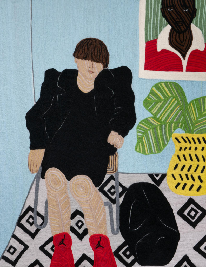 Textile work depicting a white woman in a black dress and coat sitting in a blue-walled room next to a big fern and a framed portrait of a Black man