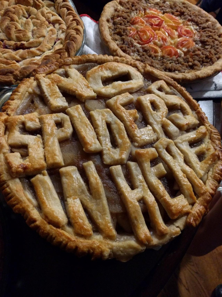 A pie with crust that spells out "No Spiders In Here"