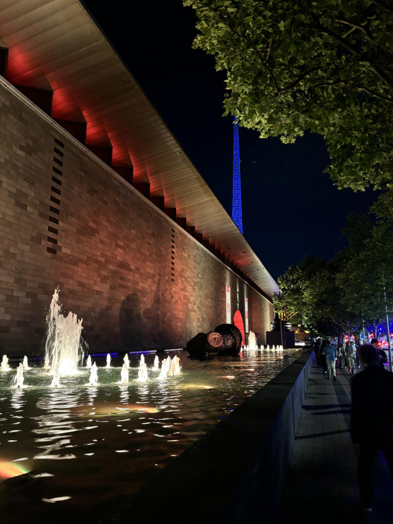 View of NGV art gallery and Arts Centre spire by night.