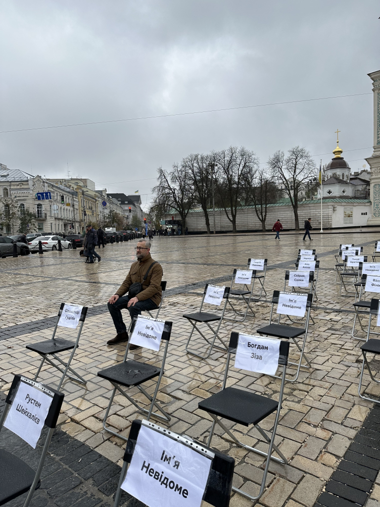 Another formerly imprisoned artist has taken his seat beside many chairs that remain empty. 