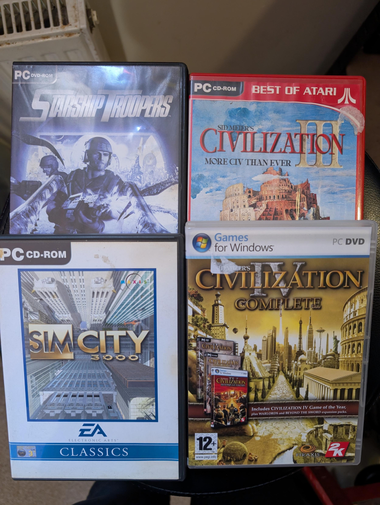 Photo of 4 PC games. Starship Troopers, Civiliation 3 and 4, and SimCity 3000.