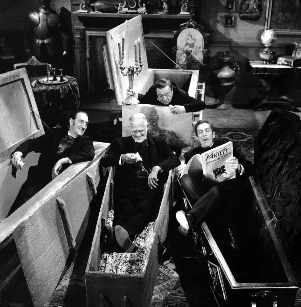 Basil Rathbone, Peter Lorrie, Vincent Price, and I think Boris Karloff all hanging around in various coffins. Lorrie is holding a lit candelabra; Price is reading Variety, apparently outloud, relaying some bit of news to everyone else, who are looking at him with interest.