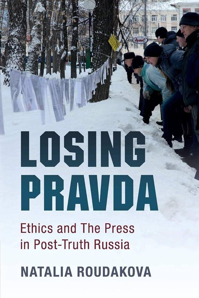 The cover of Natalia Roudakova's book, "Losing Pravda: Ethics and The Press in Post-Truth Russia." The image is of the loose pages of a newspaper all pinned, in order, along a clothesline strung between trees next to the street. A crowd of people in winter clothing stands in a snowbank along the side of the road, leaning in toward the clothesline to read the newspaper pages.