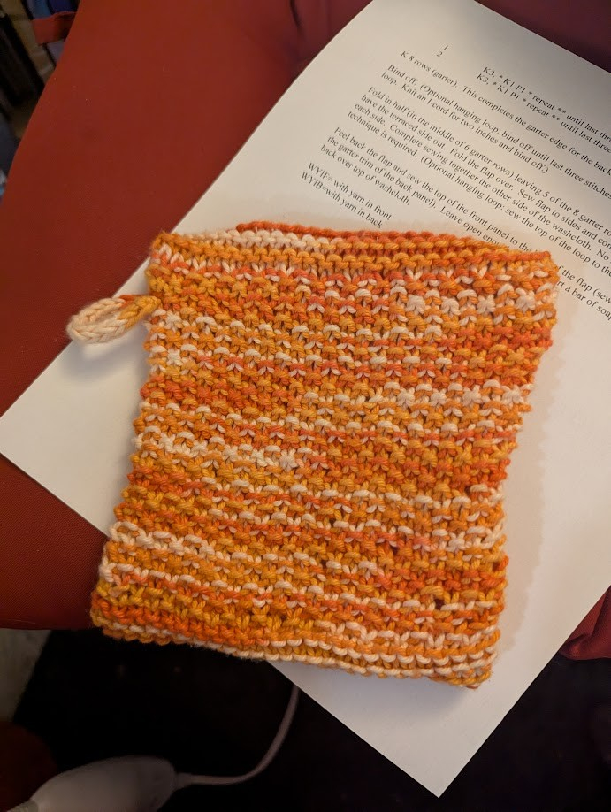 The same "soap sock", but from the back, which is simple seed stitch. There's also a small i-cord loop knitted onto it so it can be hung on a hook.