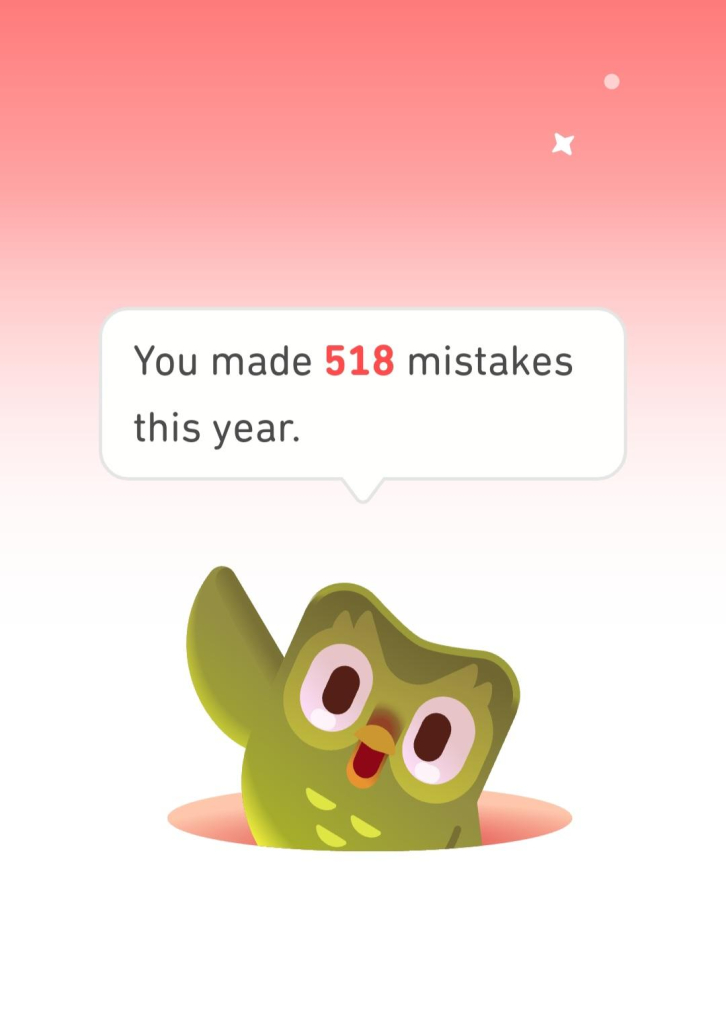 Duo, the green owl from Duolingo, popping up from a hole, waving cheerfully and saying "You made 518 mistakes this year!" 