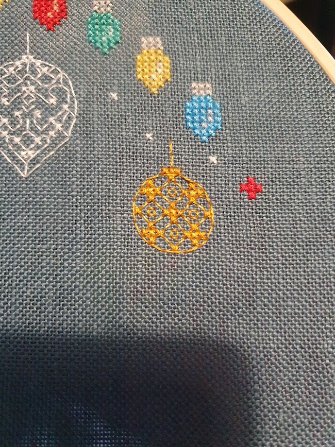 Cross stitch. 2 shades of yellow make up a Christmas bauble, partly cross stitch, partly backstitch. 