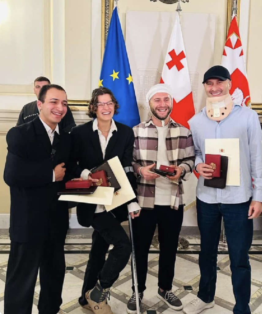 4 injured journalists pose with their civic awards.