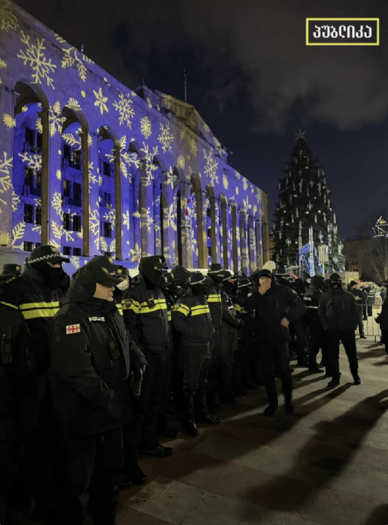 Rows of riot police guard the Christmas tree outside parliament in Tbilisi, Georgia.