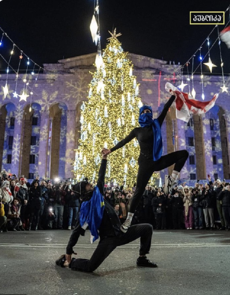 Two Georgian dancers in a pose outside parliament in Tbilisi.