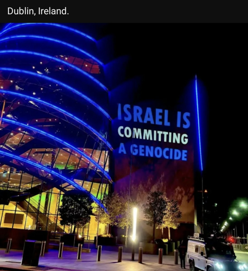 "ISRAEL IS COMMITTING A GENOCIDE" seen projected on a large glass building in Dublin, Ireland 