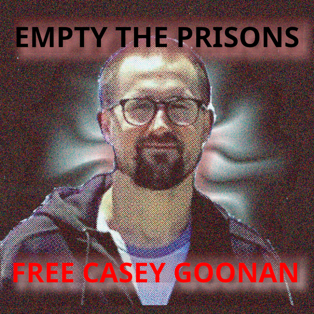 A noisy background with a newsprint image of a white man with a goatee, short shaved hair and glasses, who is presumably Casey Goonan. Text at the top reads "empty the prisons" and at the bottom "free casey goonan"