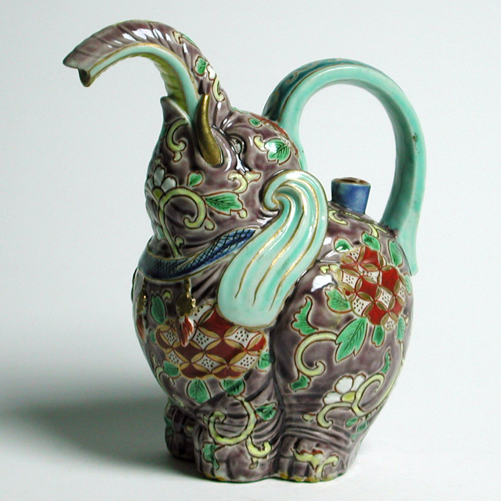 Official museum photo of the object, side profile on white background: lidded ewer in the form of an elephant, “porcelain with painting in enamel colors, iron red and gold on the glaze”