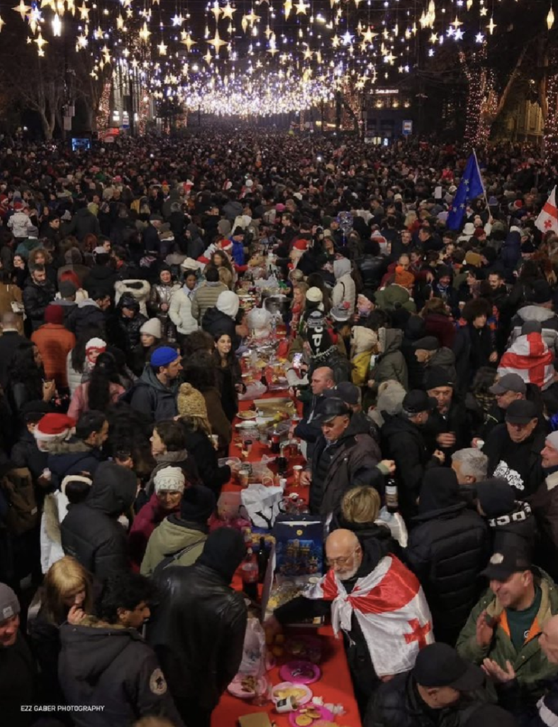 Protestors gather round a supra feast table set up outside parliament in Tbilisi, Georgia. 
Photo by Ezz Gaber.